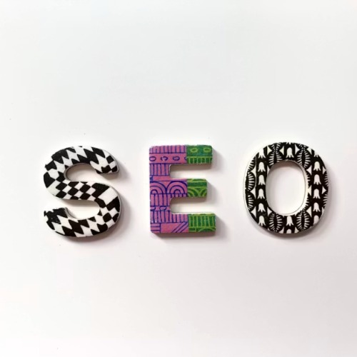 SEO letters on a white background symbolizing organic search authority with page seven marketing SEO optimization strategy.